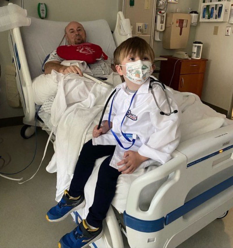 TJ Smith (rear) recovering in the hospital after open-heart surgery with his grandson, Oliver, by his side. (Photo courtesy of TJ Smith)