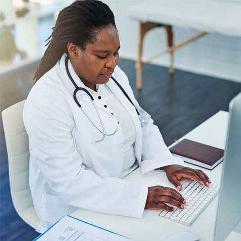 doctor typing on a keyboard