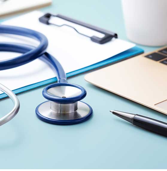 stock photo with stethoscope clipboard pen laptop