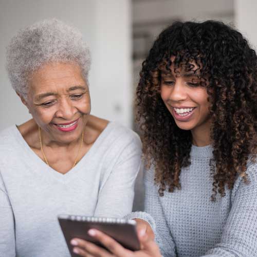 Older and younger female looking at tablet