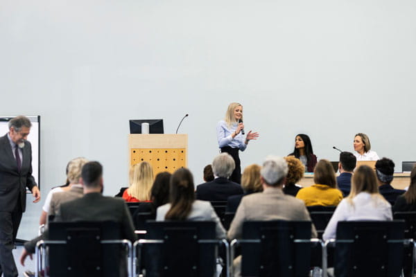 woman presenting at a conference